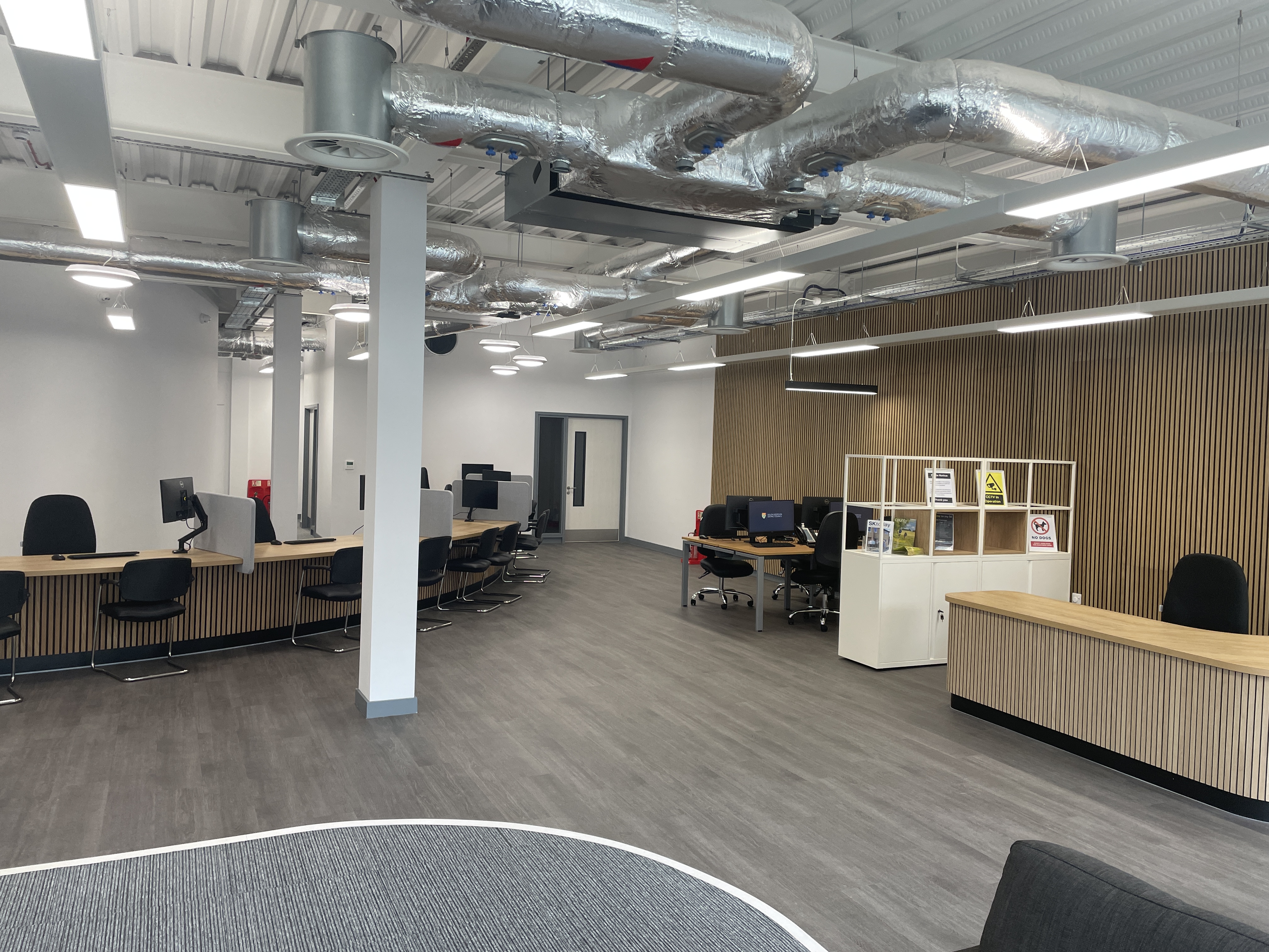 A landscape photo of the new customer services centre. Background of the photo has chairs and desks and a white space.