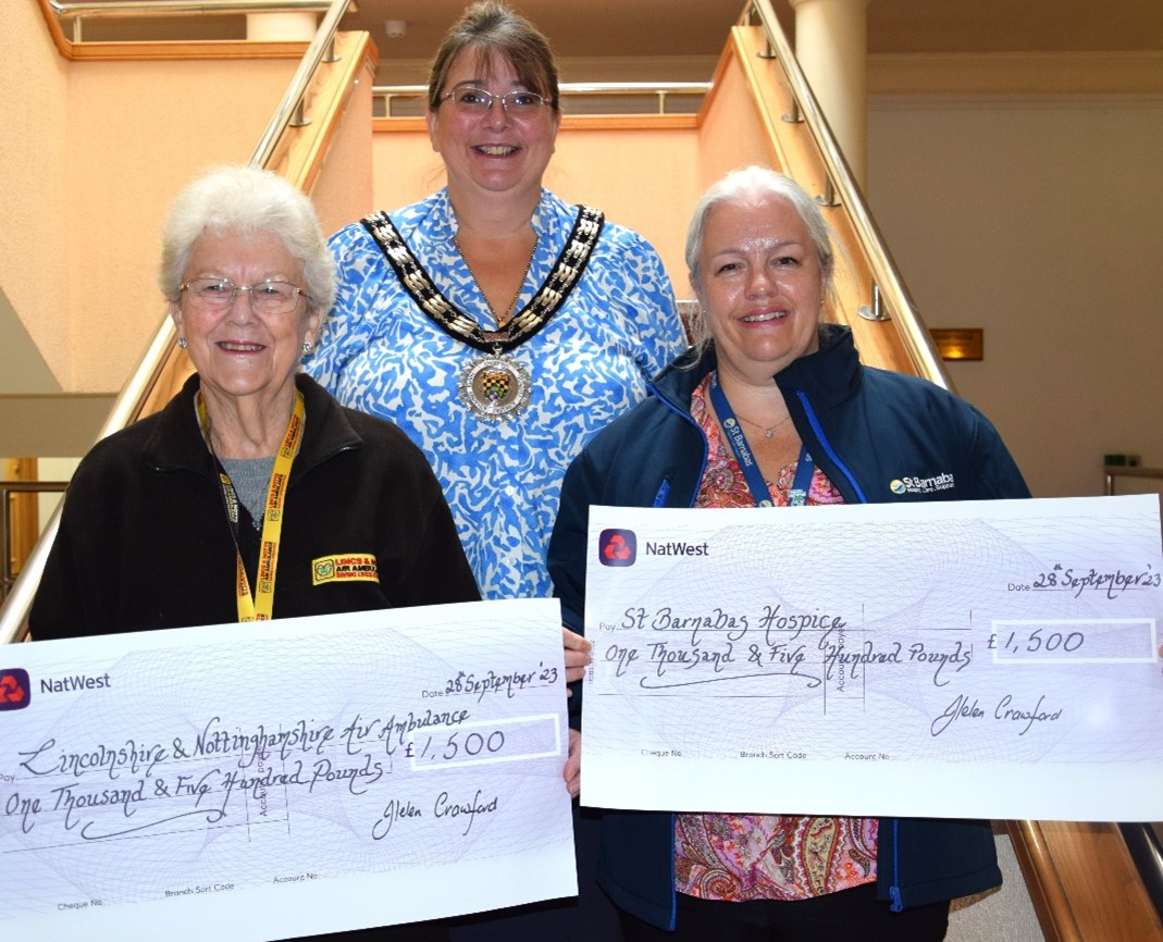 Cllr Crawford (centre) presents the cheques to Jeannie Priest, a volunteer with the LNAA, and Rebecca Franks, the director of patient care with St Barnabas Hospice.